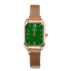 Detail of emerald green rectangular dial with rose gold mesh band and Roman numerals