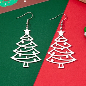 Hollow Christmas tree drop earrings with star accent on a festive red and green background