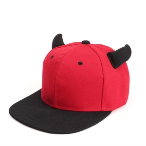 Detailed side view of a red and black hip hop hat featuring decorative devil horns