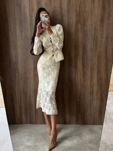 Two-piece crochet lace set featuring a long-sleeve crop jacket and midi fishtail skirt