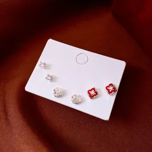 Set of six silver floral earrings featuring zircon studs and red enamel flower designs