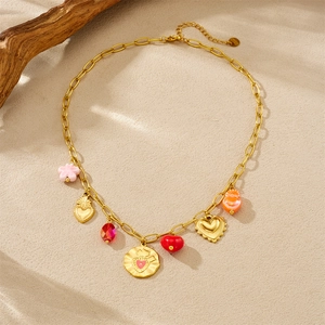 Detailed view of gold necklace with pink flower, red heart, and colorful resin pendants