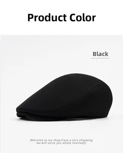 Detail of classic black cotton newsboy cap showing twill fabric texture and stitching