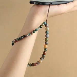 Handmade beaded phone strap with natural agate and turquoise stones worn on wrist