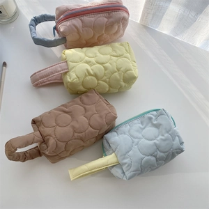 Quilted floral cosmetic bags in pink yellow and blue with portable side handles