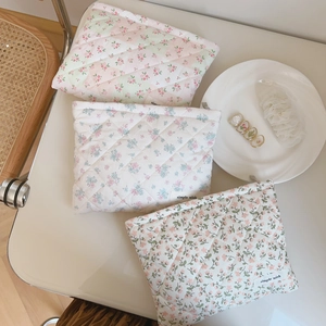 Three quilted floral cosmetic bags with delicate patterns and simple wish woven labels