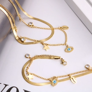 Gold double-layer Evil Eye necklace and bracelet set with star charms and crystals