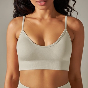 Close-up of seamless beige yoga bra with thin straps and ribbed texture details