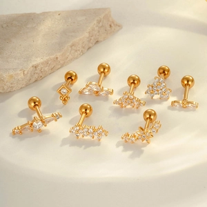 8-piece set of gold flower cartilage earrings with cubic zirconia in a ceramic tray