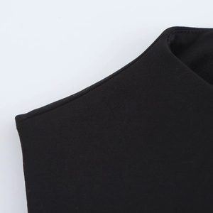 Close-up detail of high-quality stitching and faux fur texture on a black bodycon dress