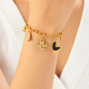 Gold stainless steel charm bracelet featuring black heart and floral pendants for women