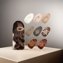 Detailed close-up of hollowed-out acetate hair claws in various colors and patterns