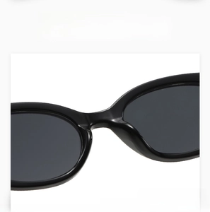 Detailed close-up of comfortable integrated nose pads on black oval sunglasses