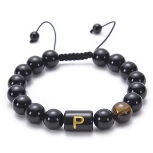 Macro detail of adjustable black onyx bead bracelet with tiger eye stone and letter P charm