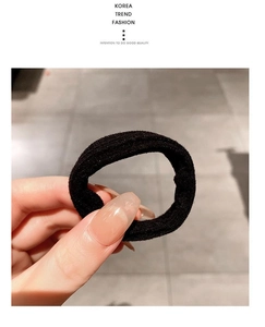 Detail of high-elasticity black knitted hair ties showcasing durable woven texture