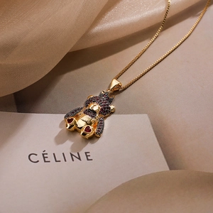 Detail of 18K gold-plated bear pendant with purple zircon and red heart on box chain