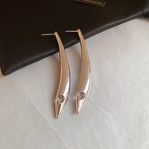 Detailed view of silver leaf-shaped long drop earrings with a sleek metallic finish