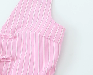 Close-up of pink and white striped cotton fabric with delicate tie-up shoulder straps