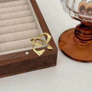 Retro S925 sterling silver gold-plated geometric cross ring on wooden jewelry display