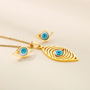 Detail view of gold Evil Eye jewelry set featuring blue resin eyes and openwork design