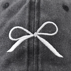 Washed dark gray baseball cap with white bow embroidery and high-quality twill texture