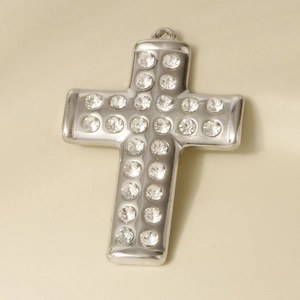 Macro view of a 304 stainless steel cross pendant with sparkling inlaid rhinestones