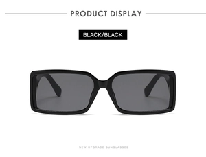 Detail view of black rectangular sunglasses with premium thick frames and dark lenses