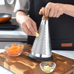 Cone-shaped stainless steel grater with wooden handle and non-slip base in kitchen use