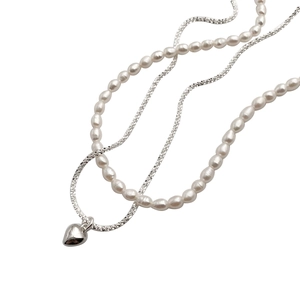 Double-layer necklace with white freshwater pearls and silver chain featuring a heart pendant