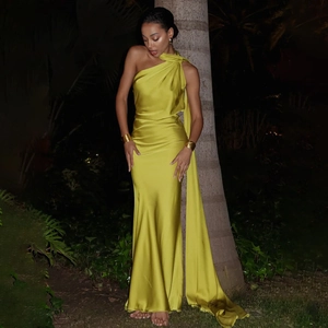 Detail of yellow one-shoulder satin dress with long ribbons and elegant slim fit design