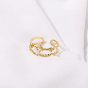 Detail of gold-plated double-layer ring featuring a star shape and sparkling zircon stones