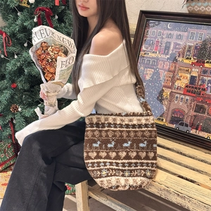 Detailed plush tote bag showing Nordic jacquard patterns and reindeer motifs in a cozy scene