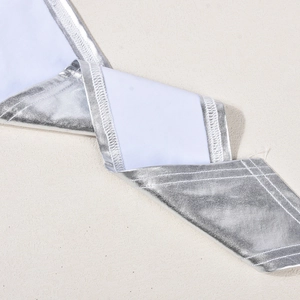 Macro detail of silver reflective fabric texture with high-quality edge stitching work