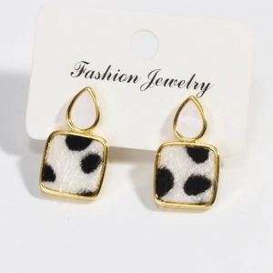Detail of leopard print faux fur and golden frame on teardrop dangle earrings