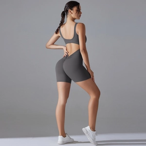 Detail of grey racerback yoga bodysuit with cutout back and scrunch butt lifting design