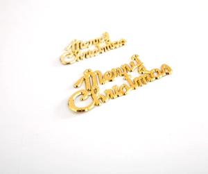 Detail of golden Merry Christmas lettering cake toppers with reflective metallic texture
