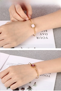 Detail of 18k gold plated stainless steel bangles with square zircon gemstones on a wrist