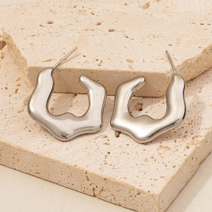 Detailed view of silver 304 stainless steel hoop earrings with irregular wave design
