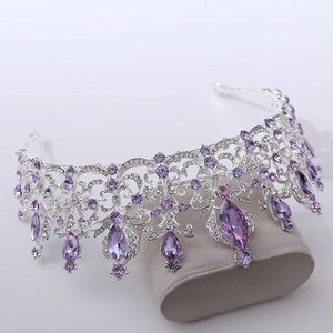 Close-up of silver bridal crown featuring teardrop purple crystals and shiny rhinestones