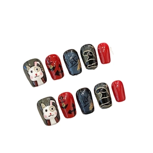Handmade red and black bunny press-on nails featuring cute cartoon art and anchor designs