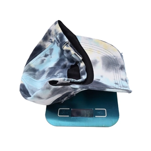 Blue and white tie-dye cotton baseball cap displayed on a digital scale weighing 79g