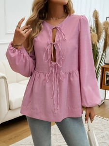 Detailed close-up of pink and white striped lantern sleeves and ruffle hem design
