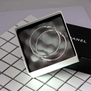 Oversized silver hoop earrings with delicate pave rhinestones in a white gift box