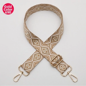 Detail of adjustable geometric diamond pattern bag strap with gold metal hooks