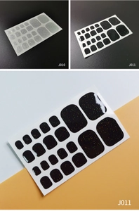 Detail of silver and black glitter toe nail wraps showing various sizes for easy application