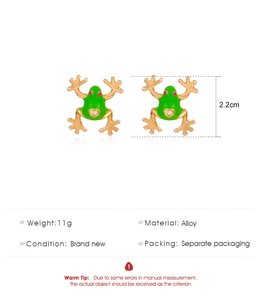 Detail view of green enamel frog earrings with red stone eyes and dimensions info