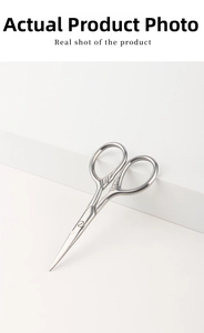 Close-up of vintage stainless steel beard scissors with embossed patterns on handle