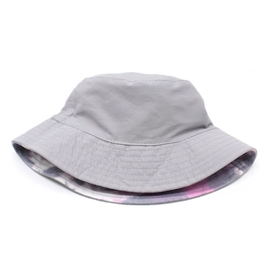 Detail showing the reversible cotton canvas bucket hat in grey and purple tie-dye pattern