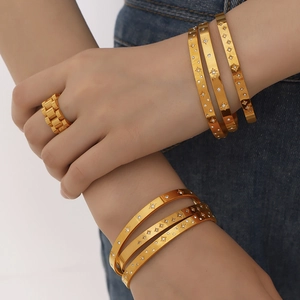 18K gold plated stainless steel bangles with starburst pattern and zircon stones