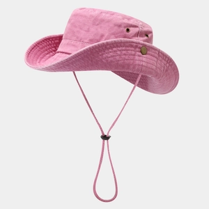 Detail of pink wide-brim sun hat featuring breathable metal eyelets and adjustable wind cord